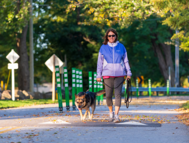 woman and a dog walking on the multi use path